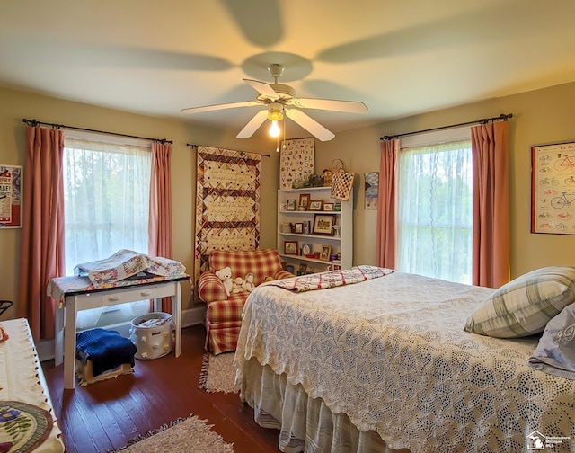 bedroom with ceiling fan, dark hardwood / wood-style floors, and multiple windows