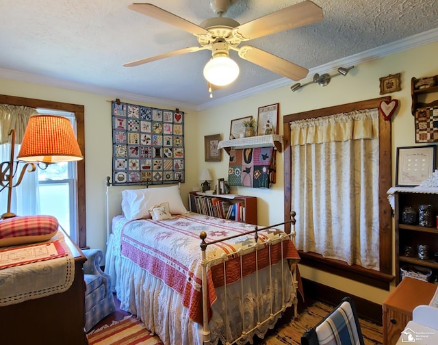 bedroom featuring ceiling fan, crown molding, hardwood / wood-style floors, and a textured ceiling