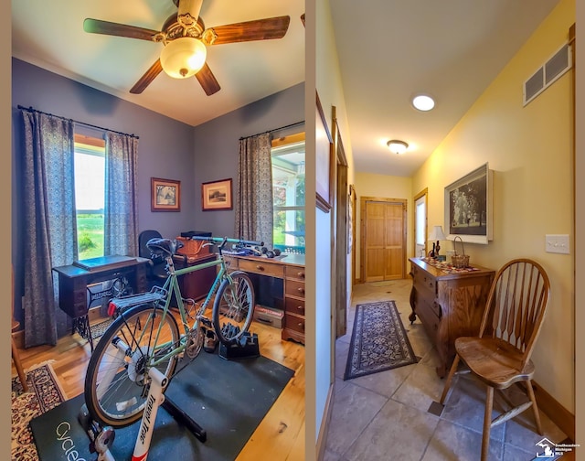 office space featuring ceiling fan, light hardwood / wood-style floors, and lofted ceiling