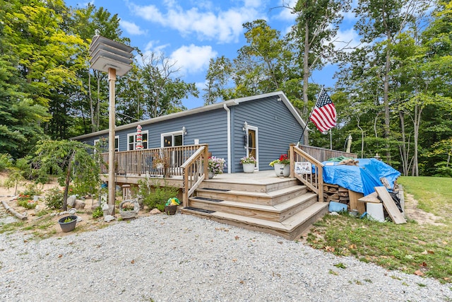 back of house featuring a wooden deck