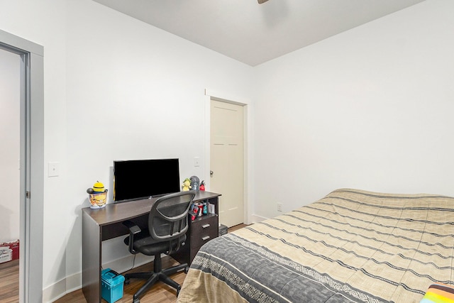 bedroom with hardwood / wood-style flooring