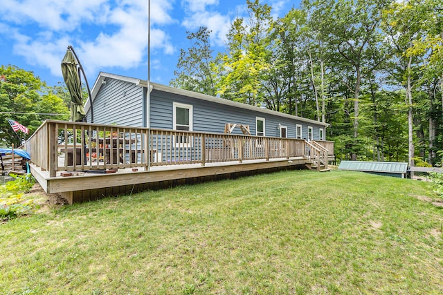 back of property featuring a deck and a yard