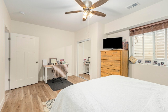 bedroom featuring ceiling fan, light hardwood / wood-style floors, and a closet