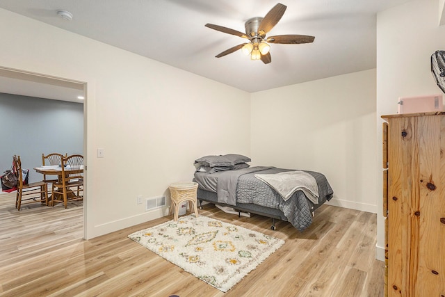 bedroom with ceiling fan and light wood-type flooring