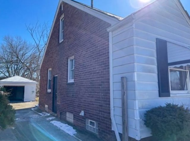 view of home's exterior with a garage and an outdoor structure