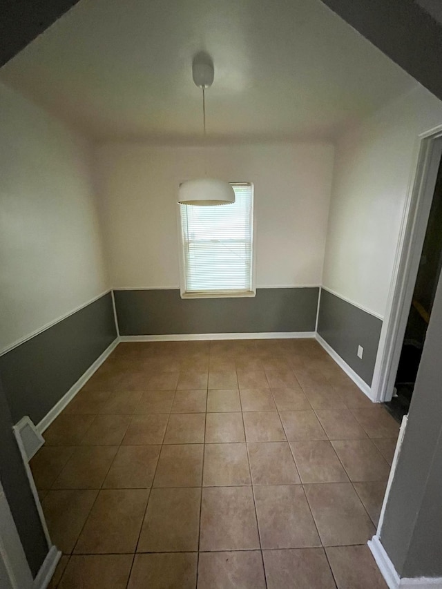 unfurnished dining area featuring tile patterned floors