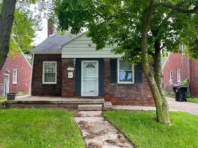 bungalow-style home featuring a front yard