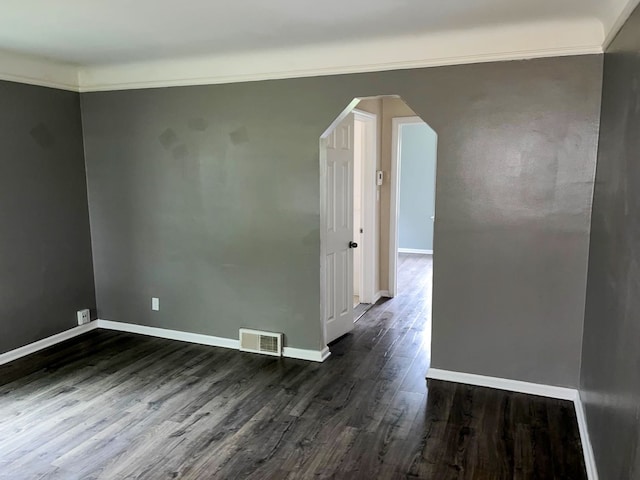 unfurnished room featuring dark hardwood / wood-style floors and ornamental molding