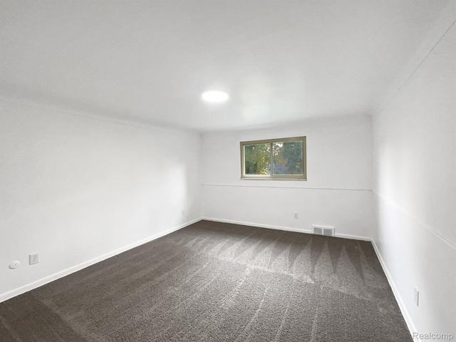 53044 Ruann Dr, Shelby Twp, MI 48316 - spare room featuring dark colored carpet and baseboards