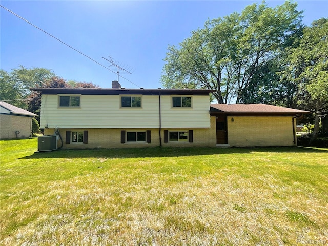 53044 Ruann Dr, Shelby Twp, MI 48316 - rear view of house with brick siding and a yard