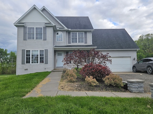 view of front of property with a front yard and a garage