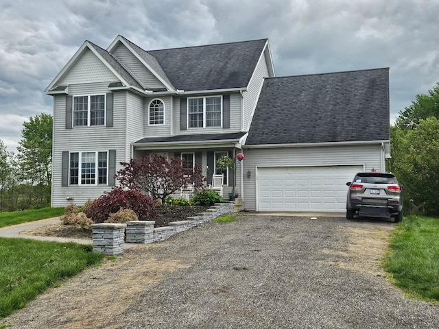 view of front of property with aphalt driveway, a porch, and a garage