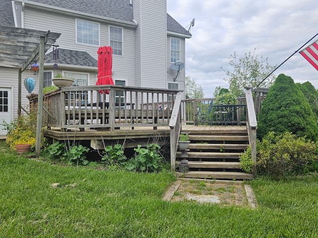 deck with a pergola and a lawn