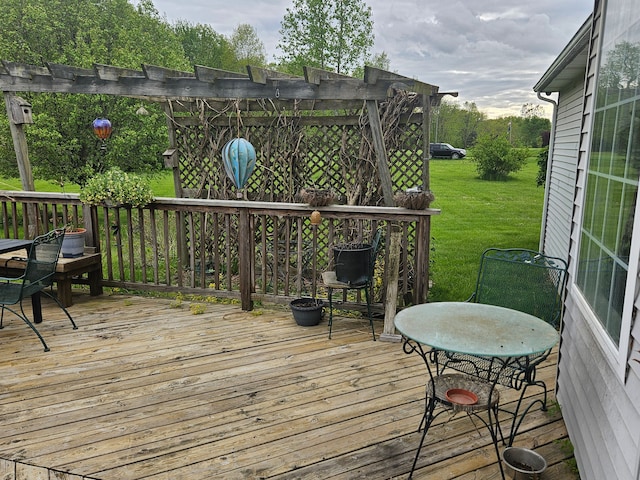 deck featuring a lawn and a pergola