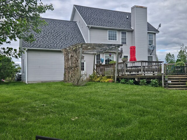 rear view of house with a pergola, a yard, and a wooden deck