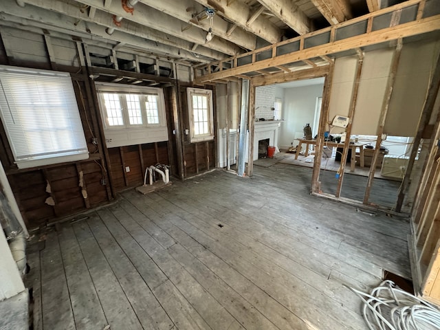 misc room featuring hardwood / wood-style floors and a brick fireplace