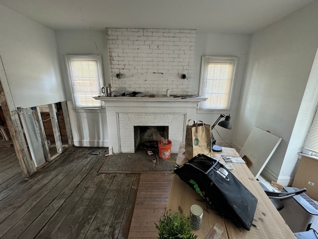 interior space with plenty of natural light, dark hardwood / wood-style flooring, and a fireplace