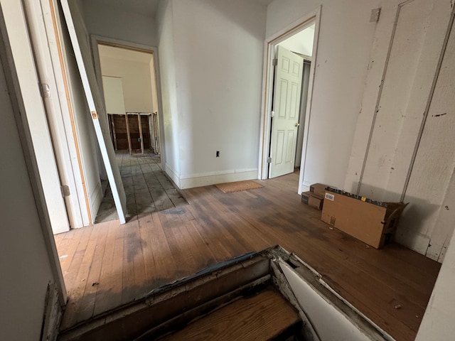 hallway with hardwood / wood-style floors