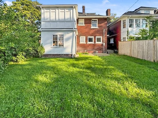 back of house with a lawn