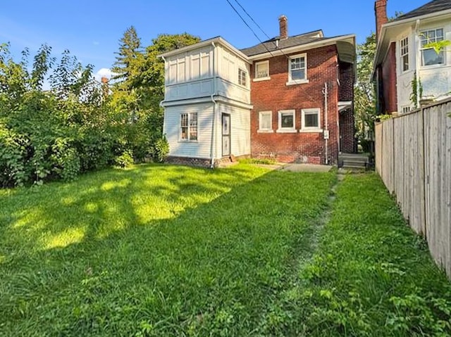 back of house featuring a yard