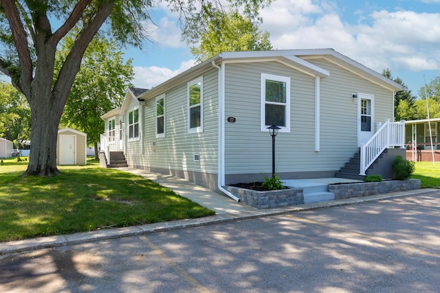 714 Mill St Unit 27, Leslie, MI 49251 - view of side of home with a yard and stairs