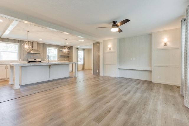 714 Mill St Unit 27, Leslie, MI 49251 - unfurnished living room with a sink, light wood-style flooring, a ceiling fan, a chandelier, and recessed lighting