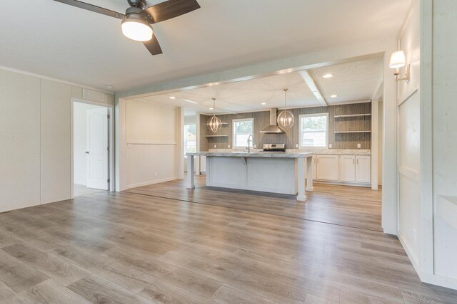 714 Mill St Unit 27, Leslie, MI 49251 - kitchen featuring a ceiling fan, light wood finished floors, wall chimney exhaust hood, open shelves, and recessed lighting