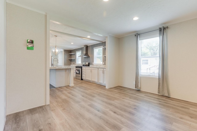714 Mill St Unit 27, Leslie, MI 49251 - kitchen with open shelves, stainless steel gas stove, wall chimney range hood, healthy amount of natural light, and recessed lighting