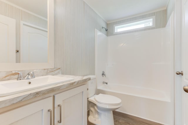 714 Mill St Unit 27, Leslie, MI 49251 - full bath featuring vanity, ornamental molding, tub / shower combination, wood finished floors, and toilet