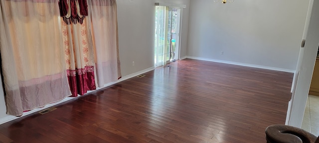 spare room with dark hardwood / wood-style flooring