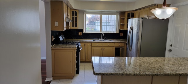 kitchen with black gas stove, sink, stainless steel fridge, tasteful backsplash, and light tile patterned flooring