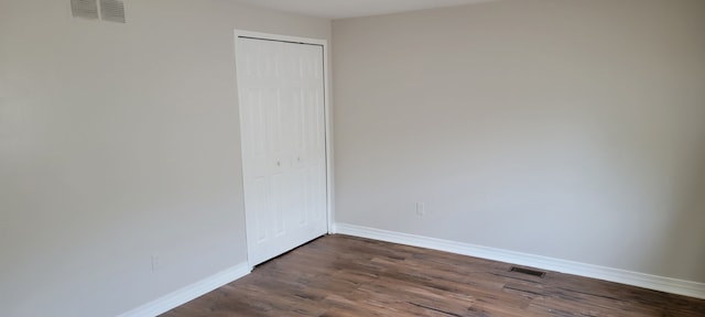 spare room featuring dark hardwood / wood-style floors