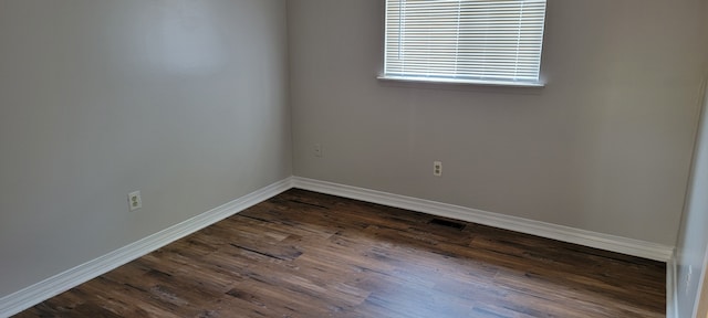 spare room featuring dark hardwood / wood-style floors