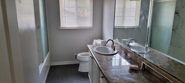 full bathroom with tile patterned flooring, vanity, toilet, and shower / bath combination with glass door