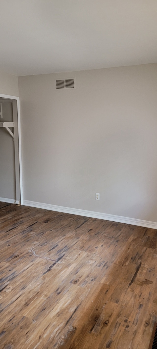 empty room with wood-type flooring