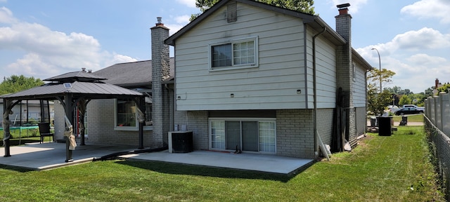 back of property featuring a gazebo, a patio area, and a yard