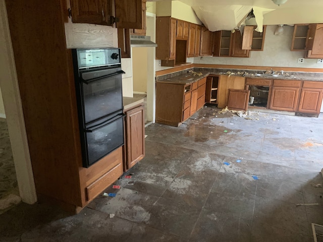 kitchen with black double oven and sink