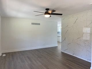spare room featuring ceiling fan and dark hardwood / wood-style flooring