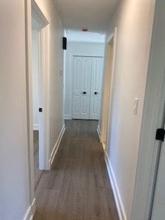 corridor with dark hardwood / wood-style floors