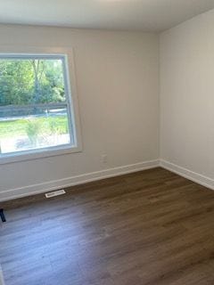 spare room featuring dark hardwood / wood-style floors