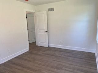 spare room with dark hardwood / wood-style flooring