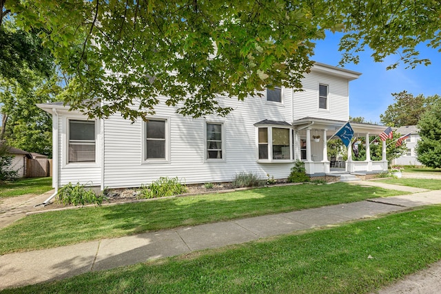 view of front of property with a front yard and a porch