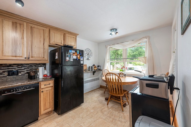 kitchen featuring radiator, decorative backsplash, dark stone counters, and black appliances