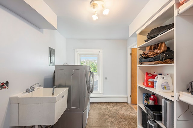 washroom featuring washer / clothes dryer, a baseboard radiator, and sink