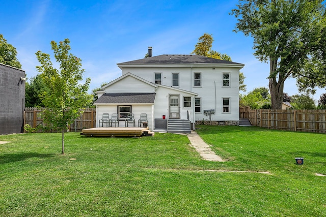 back of house with a wooden deck and a lawn