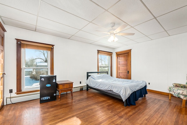 bedroom featuring ceiling fan, a paneled ceiling, and hardwood / wood-style flooring