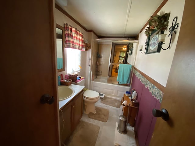 full bathroom with crown molding, toilet, vanity, and combined bath / shower with glass door