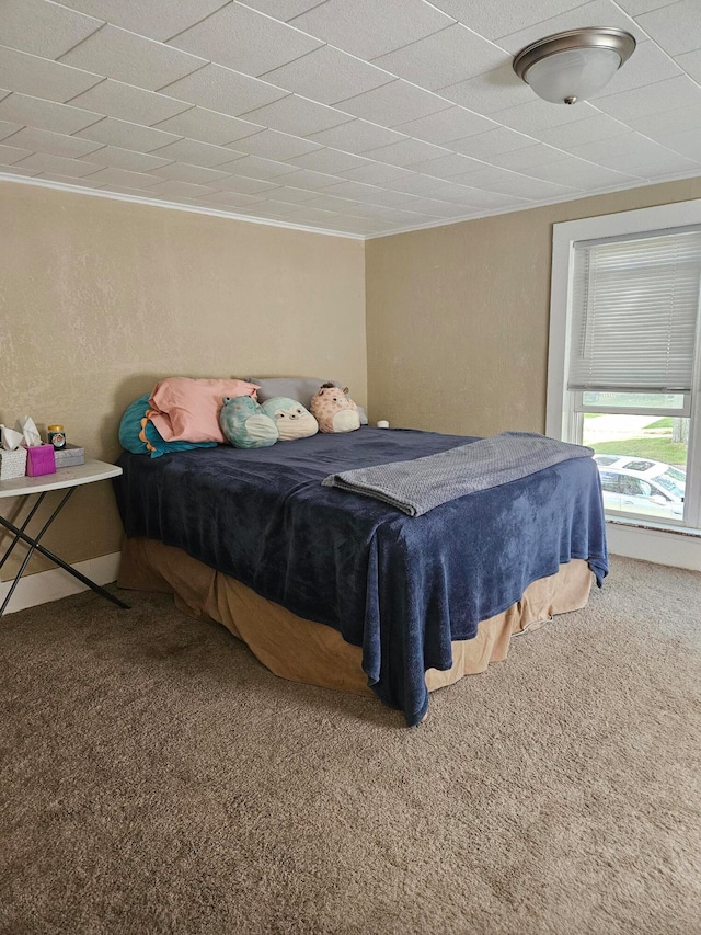 carpeted bedroom featuring crown molding