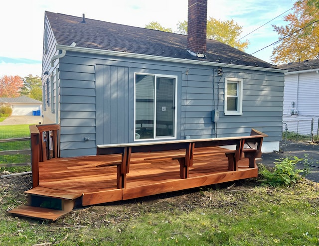 back of property featuring a wooden deck