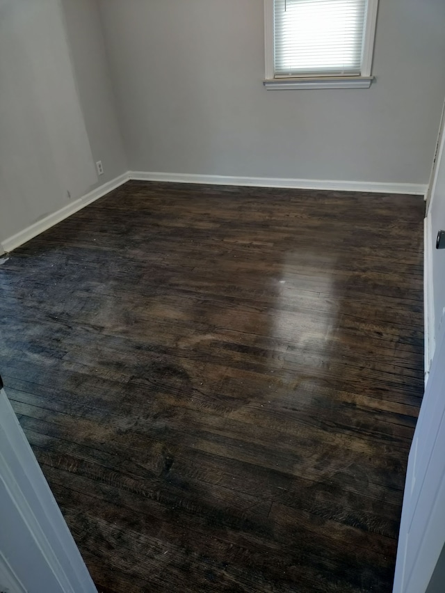 unfurnished room with dark hardwood / wood-style floors